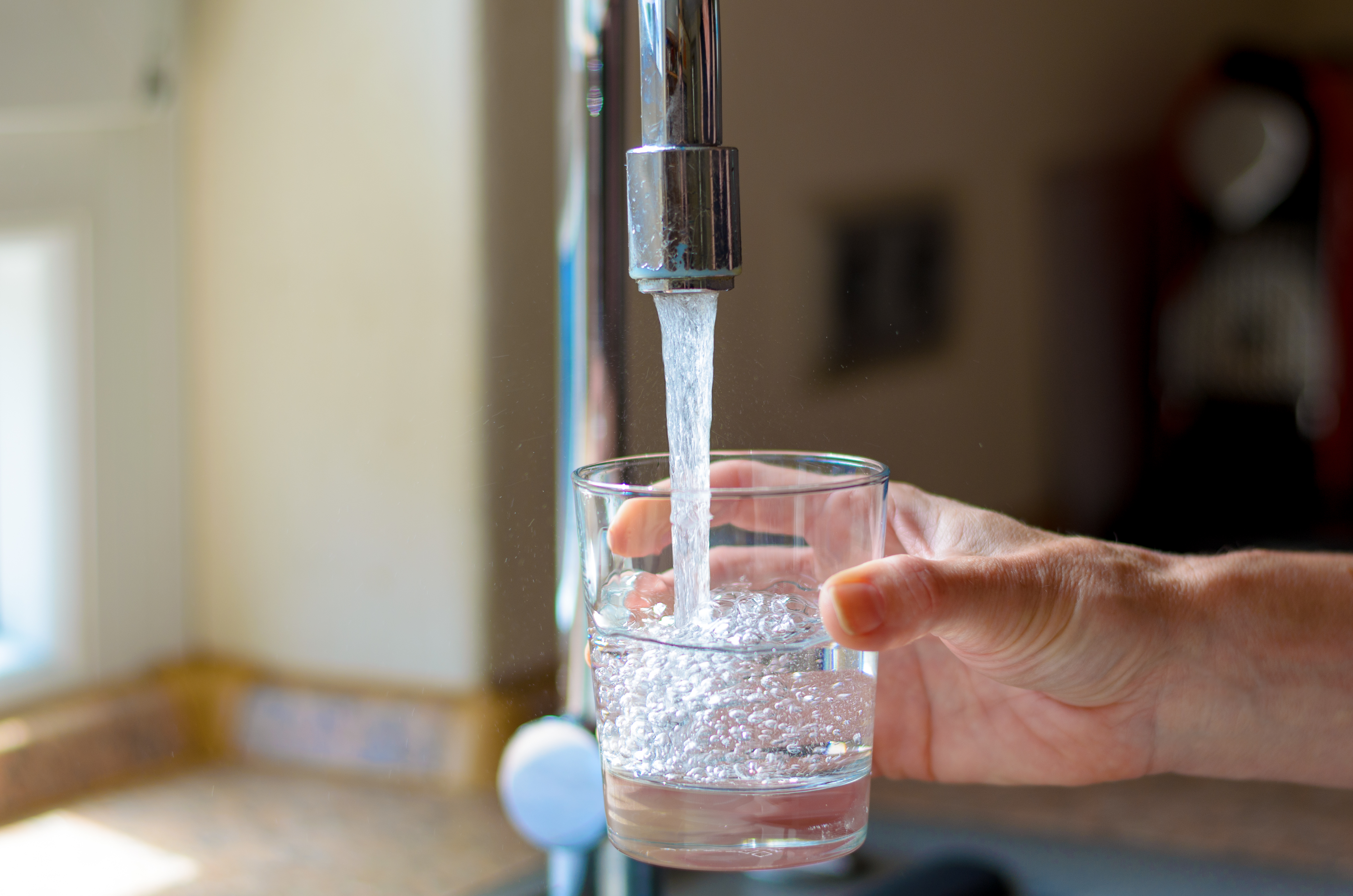 faucet filling glass with water